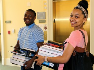 2013 S.E.P. scholars Demarre Richmond and Chelsea Suitt collect stacks of books and supplies for the program.